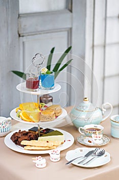 Afternoon tea. Tea party with unicorn macarons, scones, bakeries