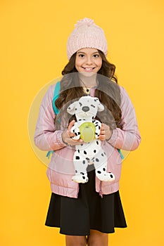 Afterschool special. Happy girl go to afterschool with toy dog. Little schoolchild yellow background. Afterschool time