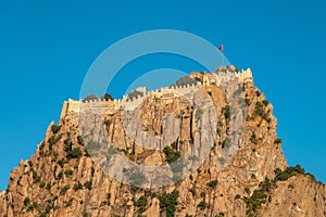 Afyon castle on the rock in Afyonkarahisar Turkey in front of a sunny blue sky