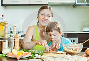 again makes salmon dumplings (pelmeni) on the inside of the kitchen