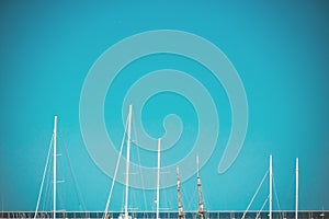 Against the backdrop of the blue sky and the horizon of the Balearic Sea, the white masts of yachts