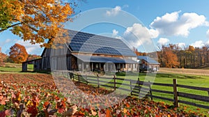 Against a backdrop of colorful autumn leaves a picturesque farmhouse and its adjacent barn boast sleek and modern solar