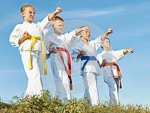 Against the background of the blue sky, children training blow hand