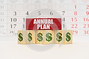 Against the background of the calendar, cubes and a plate with the inscription - Annual Plan