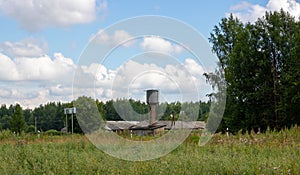 Against the background of the countryside, a water storage tank. the tower is a metal structure