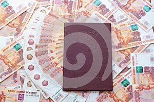 Against the background of five-thousandth bills is a red diploma with honors