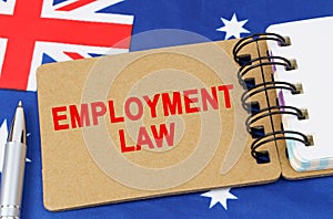 Against the background of the flag of Australia lies a notebook with the inscription - EMPLOYMENT LAW