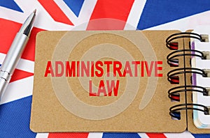 Against the background of the flag of Great Britain lies a notebook with the inscription - ADMINISTRATIVE LAW