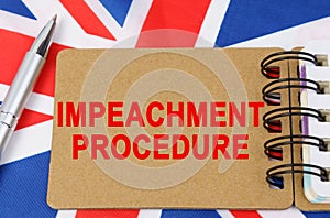 Against the background of the flag of Great Britain lies a notebook with the inscription - IMPEACHMENT PROCEDURE