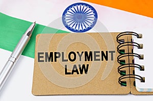 Against the background of the flag of India lies a notebook with the inscription - EMPLOYMENT LAW