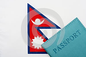 Against the background of the flag of Nepal is a passport