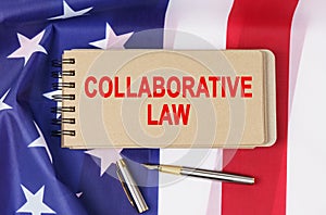Against the background of the flag of the USA lies a notebook with the inscription - COLLABORATIVE LAW