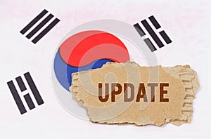 Against the background of the South Korean flag lies cardboard with the inscription - update