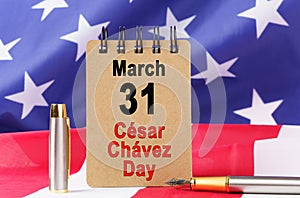 Against the background of the US flag lies cardboard with the inscription - Cesar Chavez Day