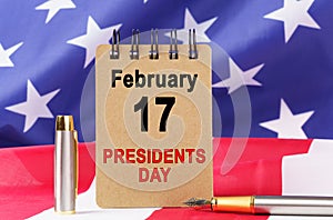 Against the background of the US flag lies cardboard with the inscription - PRESIDENT S DAY