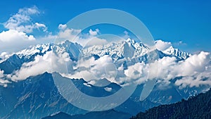 Against a clear blue sky snowcapped mountains rise majestically into the clouds creating a sense of balance and harmony