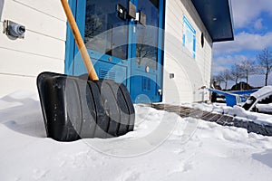 Against slippery conditions, the use of a snow shovel for freeing the street from snow . photo
