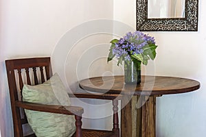 Agapanthus praecox, blue african lily flower on wooden table in home near white wall. Tanzania, east Africa