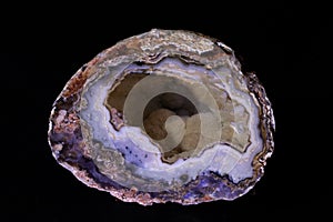 agate semigem geode with crystals isolated on black background photo