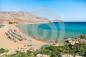 Agathi beach with holiday makers enjoying their time Rhodes, Greece