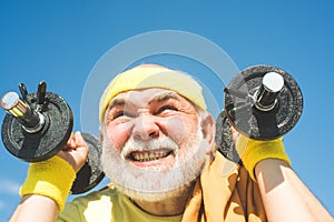 Age is no excuse to slack on your health. Senior man exercising on blue sky. Health club or rehabilitation center for