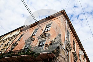 Age-old City Street Building with Balcony Statue on Corner