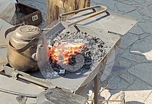 Age-old kettle on the forge fire