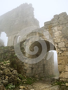 Age-old stronghold gate arched mist morning