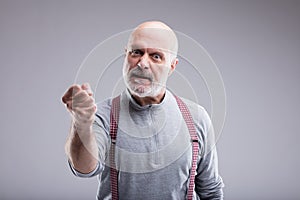 Aged angry man threatin with a punch