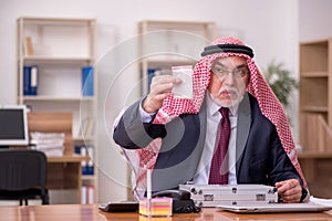 Aged arab businessman selling narcotics at workplace