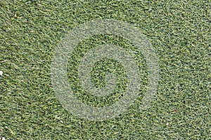 Aged artificial grass background in deep green color