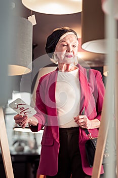 Aged attractive fancy woman holding sale sign in hand