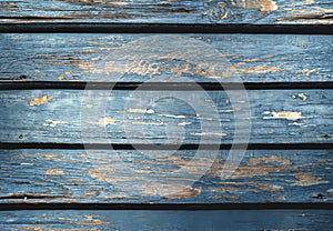 Aged blue wooden background. Planks with shriveled blue paint