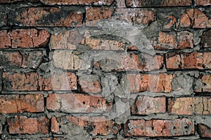 Aged brick wall background texture. Broken bricks.