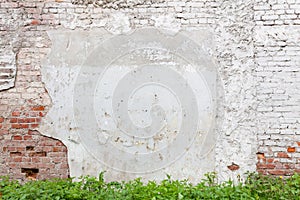 Aged brick wall with cracked plaster