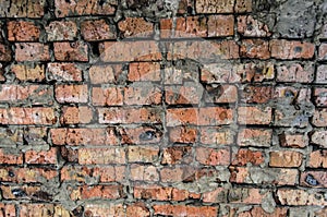 Aged brick wall under concrete cement ceiling background.. Broken bricks.