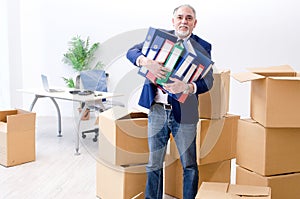 The aged businessman moving to new workplace