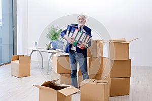 The aged businessman moving to new workplace