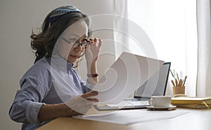 Aged businesswoman checking financial taxes fees, reviewing bank account loan rates information, medical insurance cost