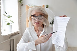 Aged businesswoman giving online presentation discuss contract details distantly