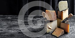 Aged cheese, Spanish, hard cheese composition with cheese knife. Long banner format