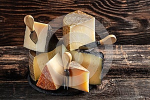 Aged cheese, Spanish, hard cheese composition with cheese knife. traditional pieces of Spanish, French, Italy cheese