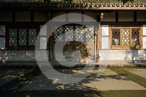 Aged Chinese traditional wooden house at sunny winter noon