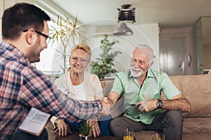 Aged couple consulting with insurance agent