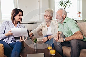 Aged couple consulting with insurance agent