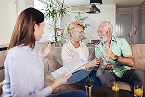 Aged couple consulting with insurance agent