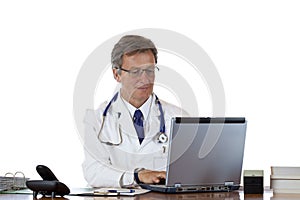 Aged doctor types medical history in laptop