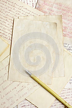 Aged empty paper sheets with vintage nib pen