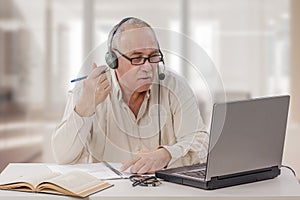 Aged freelance male tutor working online