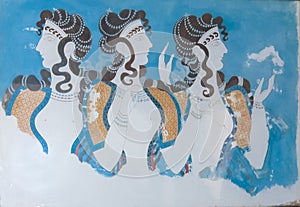 Aged fresco of three women profiles